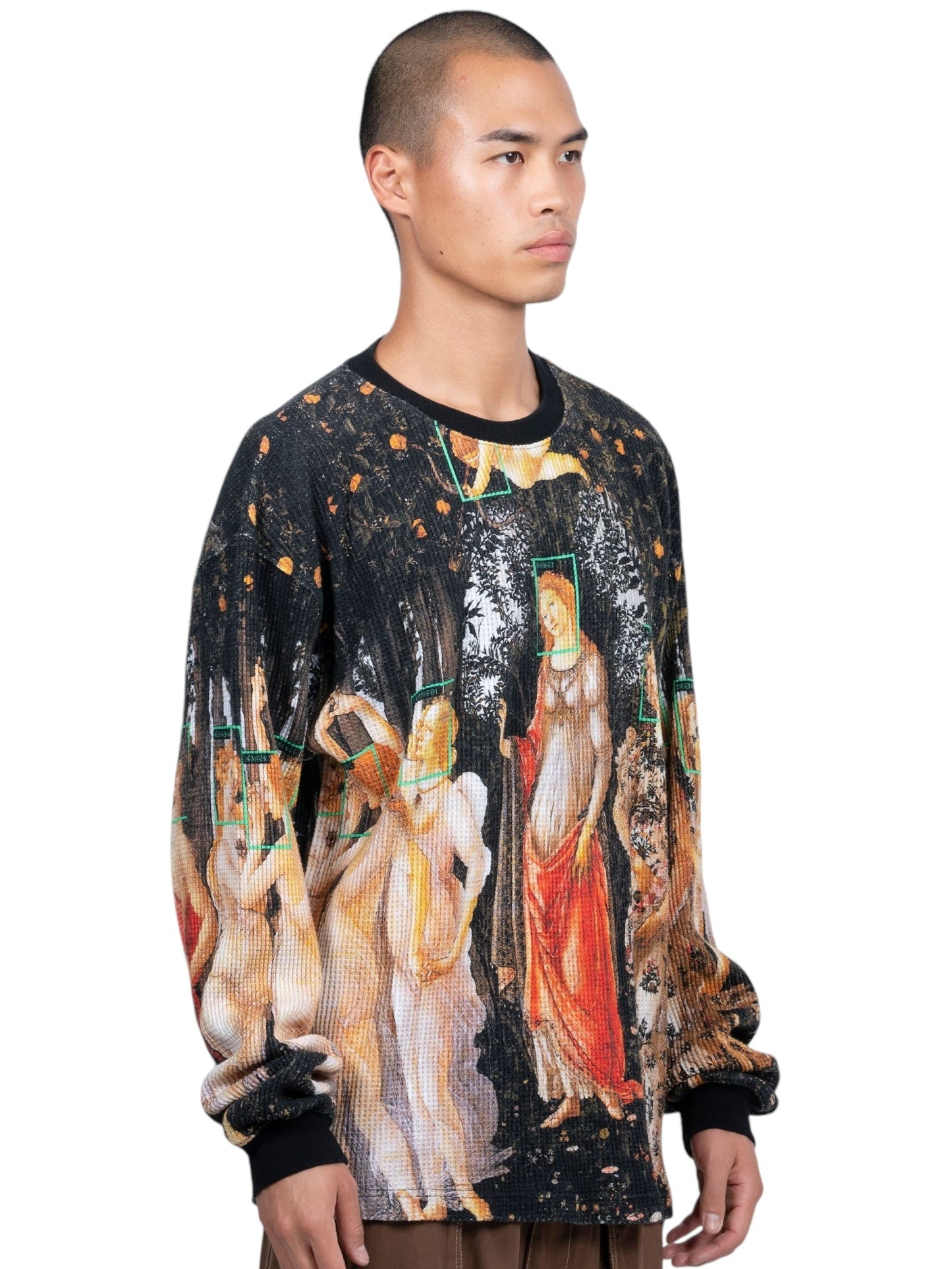 A person with a shaved head wears the Pleasures Facial Thermal L/S T-shirt in Black by PLEASURES, featuring an art print with figures and a forest scene, enhanced by a digital printed graphic on 100% cotton material.