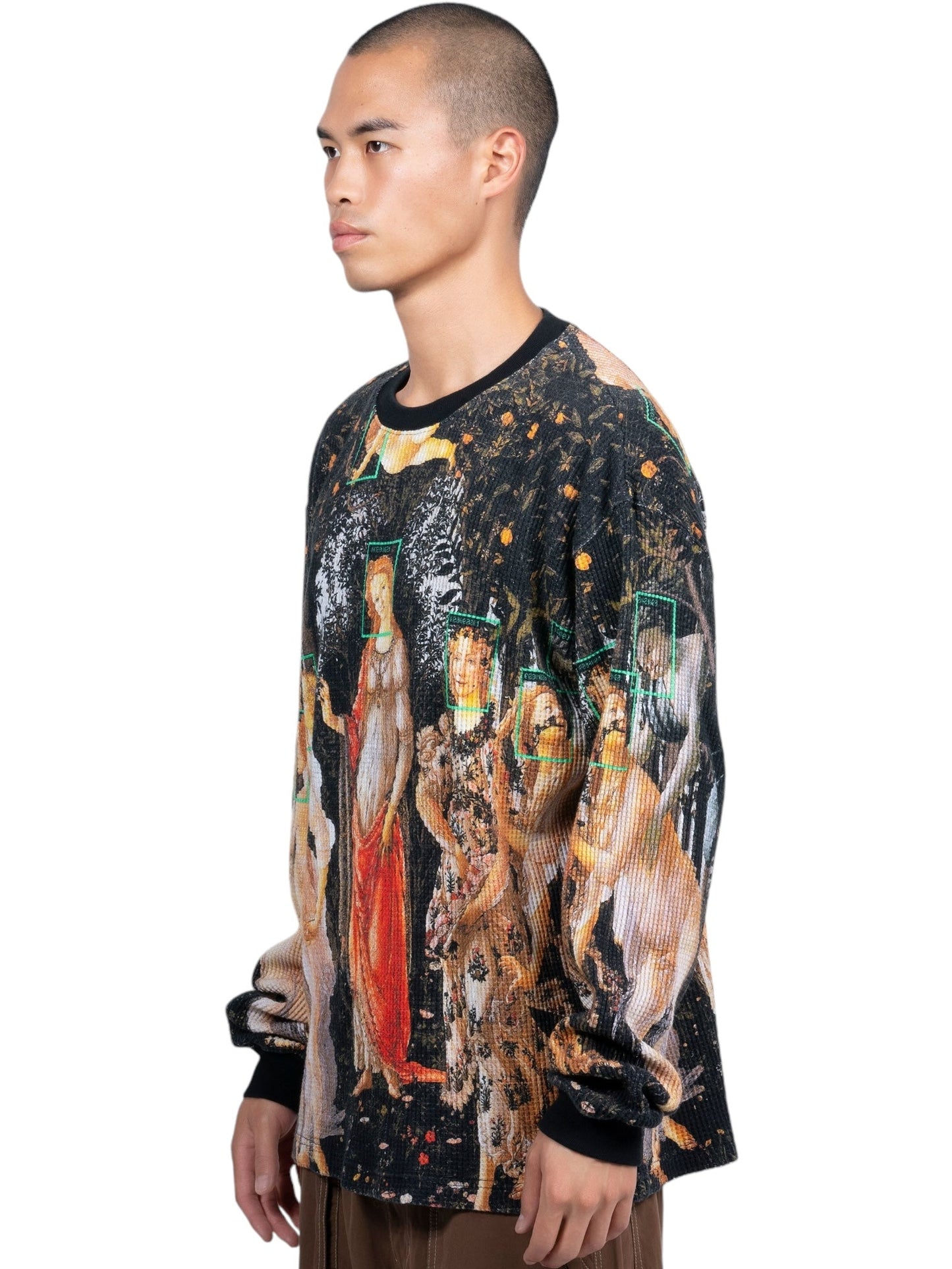 Individual dressed in a black Pleasures Facial Thermal long-sleeve T-shirt made from 100% cotton, adorned with an artistic, digitally printed graphic showcasing classical figures.