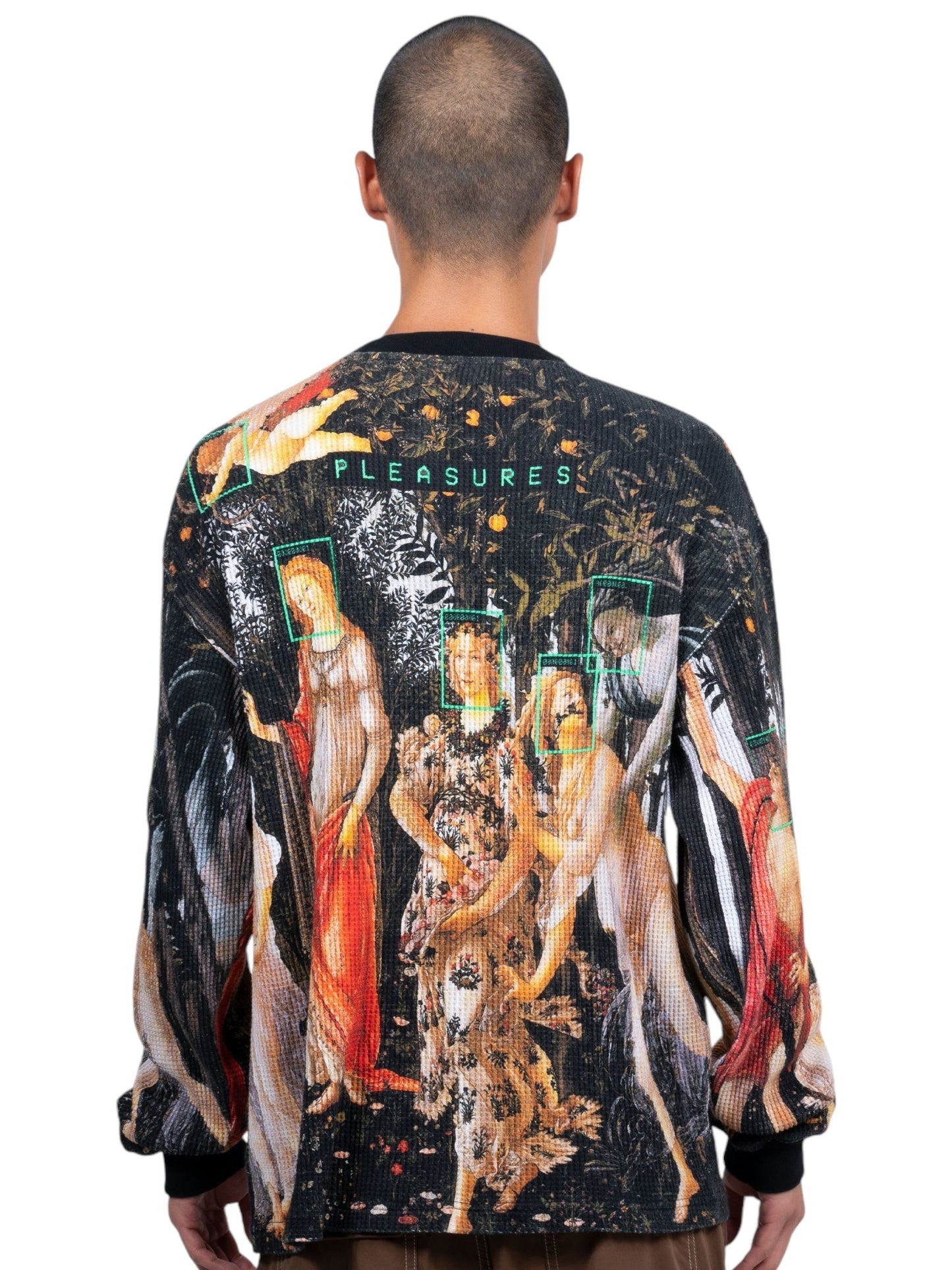 A rear view of someone wearing a vibrant, all-cotton Pleasures Facial Thermal long sleeve T-shirt in black, showcasing a digitally printed classical painting graphic with the brand name "PLEASURES" displayed prominently.