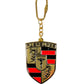The Pleasures Fast Life Keychain Multi by PLEASURES, featuring a red and black shield with a central horse and stylized symbols, embodies elegance in every detail.