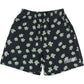 The Pleasures Floral Seersucker Shorts Black by PLEASURES feature black cotton seersucker fabric, light green clover print, and a white "PLEASURES" logo embroidered on the left leg.