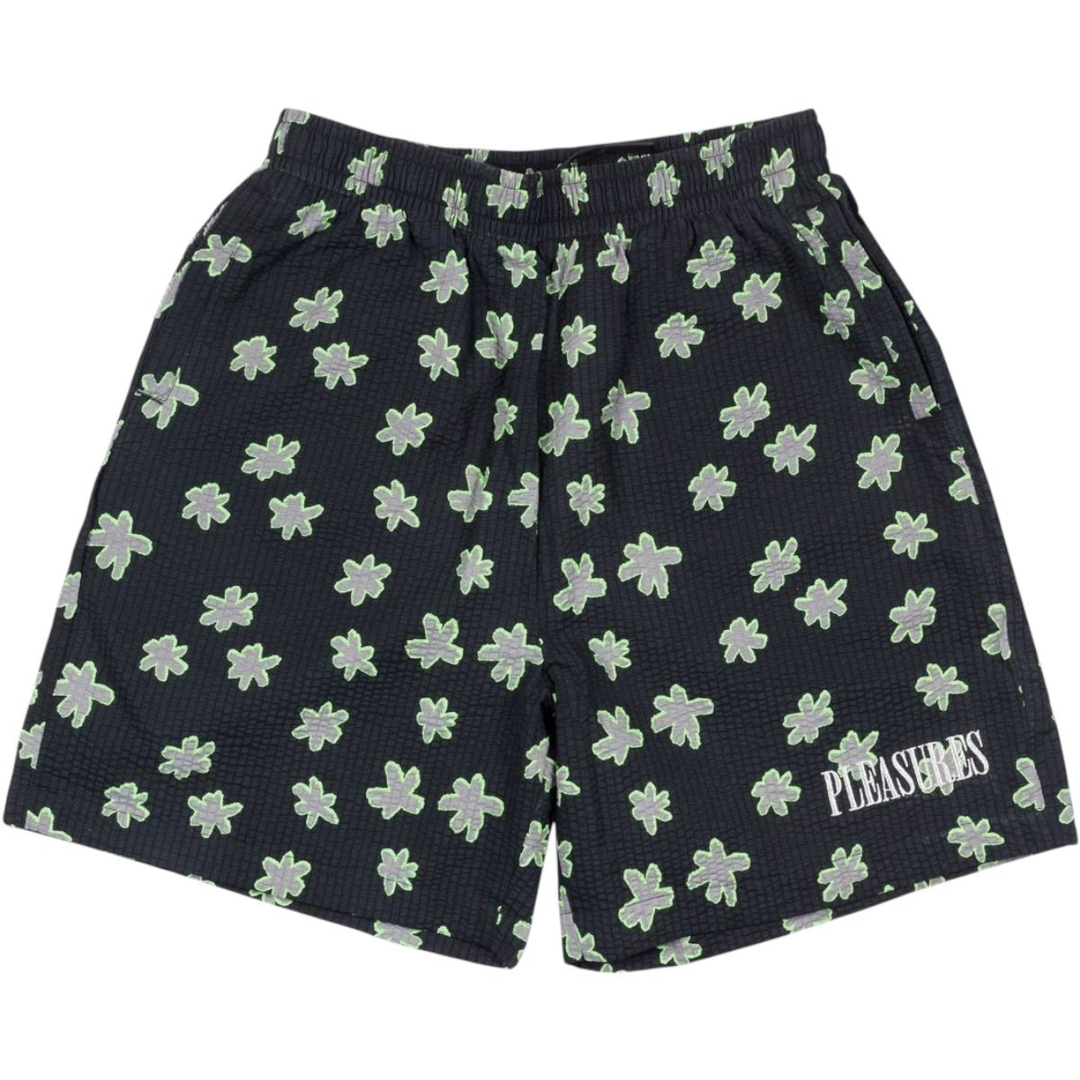 The Pleasures Floral Seersucker Shorts Black by PLEASURES feature black cotton seersucker fabric, light green clover print, and a white "PLEASURES" logo embroidered on the left leg.