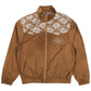The Pleasures Francesca Track Jkt Brown by PLEASURES is crafted in Italy, featuring lace detailing on the shoulders. It includes a front zipper, elastic cuffs, and pockets with "A.T.C.R.T.E.T.O." printed in small letters, offering a stylish touch reminiscent of a classic track jacket.