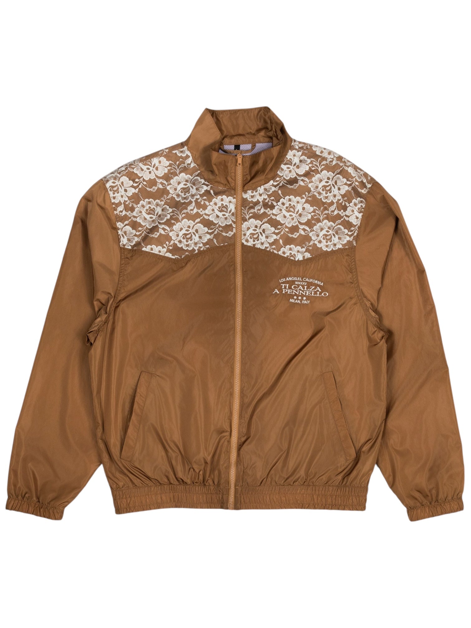 The Pleasures Francesca Track Jkt Brown by PLEASURES is crafted in Italy, featuring lace detailing on the shoulders. It includes a front zipper, elastic cuffs, and pockets with "A.T.C.R.T.E.T.O." printed in small letters, offering a stylish touch reminiscent of a classic track jacket.