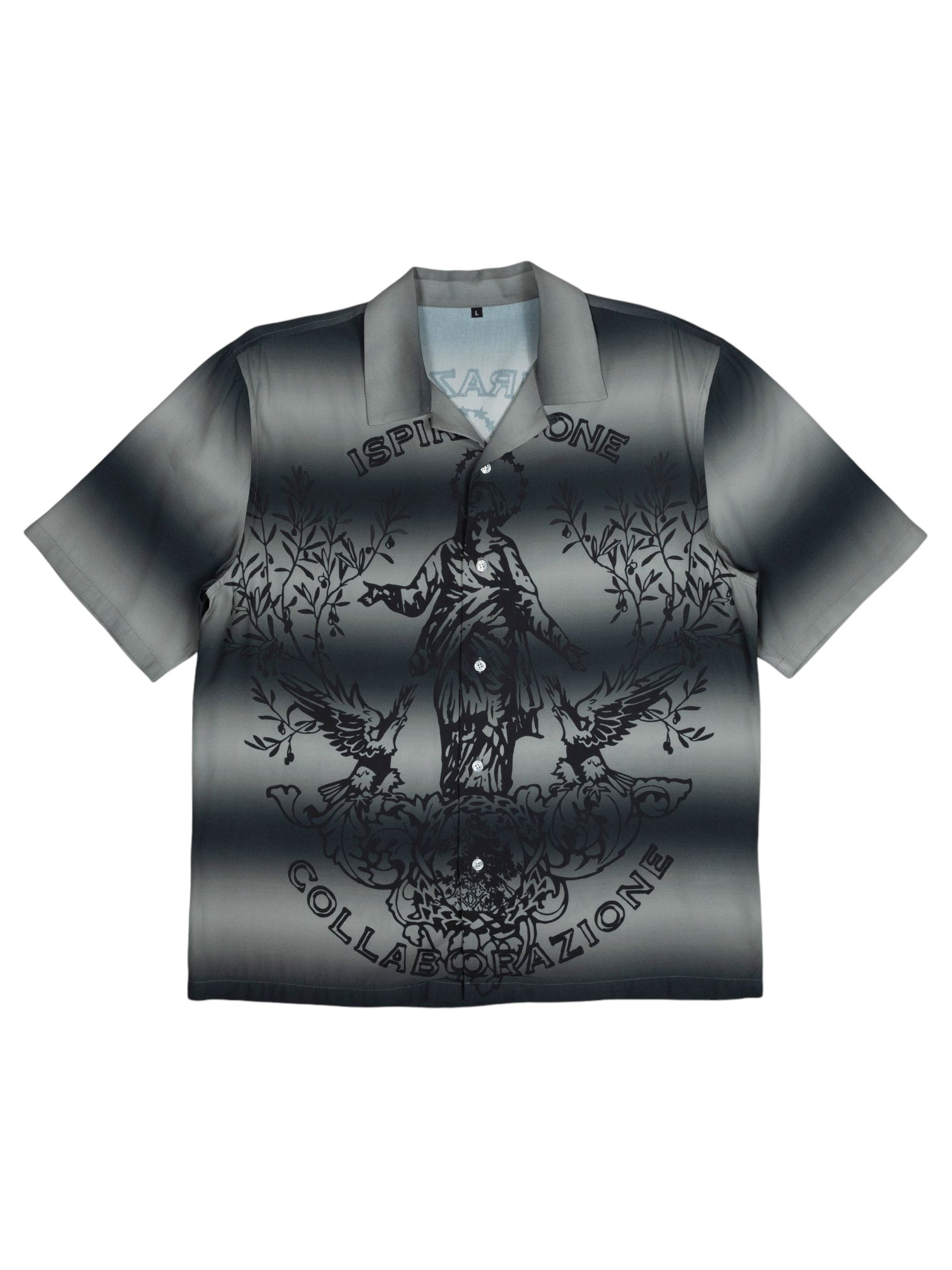 The Pleasures Giovanni BUTTON UP SILVER by PLEASURES is a short-sleeve shirt with a camp collar, grayscale gradient, and stylized central figure. "Ispirazione Collaborazione" is boldly printed on it. Made from luxurious Viscose Challis in Italy.