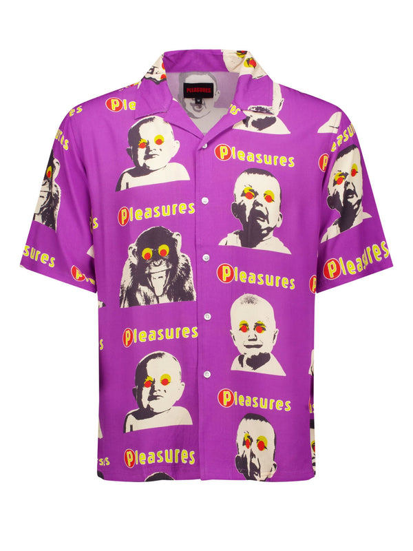 A PLEASURES HEAD BUTTON DOWN PURPLE shirt, made from 100% Rayon, features short sleeves with repeated images of babies and animals with yellow eyes. The word "PLEASURES" is printed throughout, adding a unique touch.