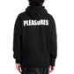 Someone wearing the Pleasures Illegal Hoodie by PLEASURES, a black cotton hoodie with "PLEASURES" in white on the back.
