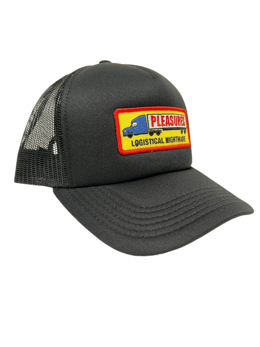 The PLEASURES NIGHTMARE TRUCKER BLACK hat features a black design with a breathable mesh back, crafted from a blend of nylon and polyester. The front showcases a patch reading "PLEASURES LOGISTICAL NIGHTMARE" alongside an image of a blue truck.
