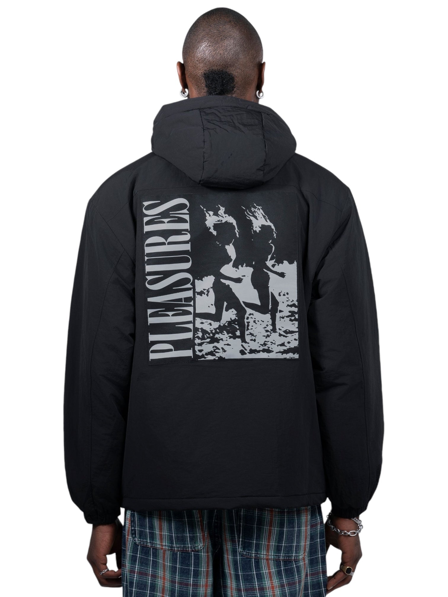 A person donned the sleek Pleasures Run Hooded Jacket in Black by PLEASURES, featuring a bold artwork on the back. This stylish piece is an attention-grabber, ideal for those who appreciate both quality and fashion.