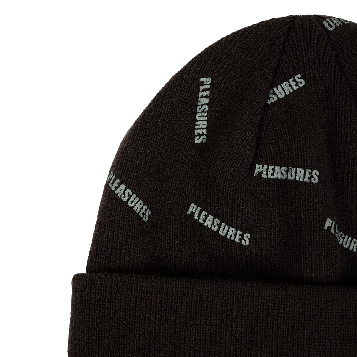 The PLEASURES SPRINKLE BEANIE BLACK features a black beanie hat adorned with the word "PLEASURES" in white text, creating a striking Pleasures logo print that repeats all over it.