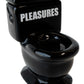 The Pleasures Toilet Cone Burner in Black, by PLEASURES, is a ceramic incense burner with "PLEASURES" on the tank lid, adding a whimsical touch to your self-care routine.