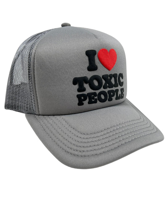 Gray PLEASURES TOXIC TRUCKER CAP BLACK with the phrase "i ❤️ toxic people" embroidered on the front.