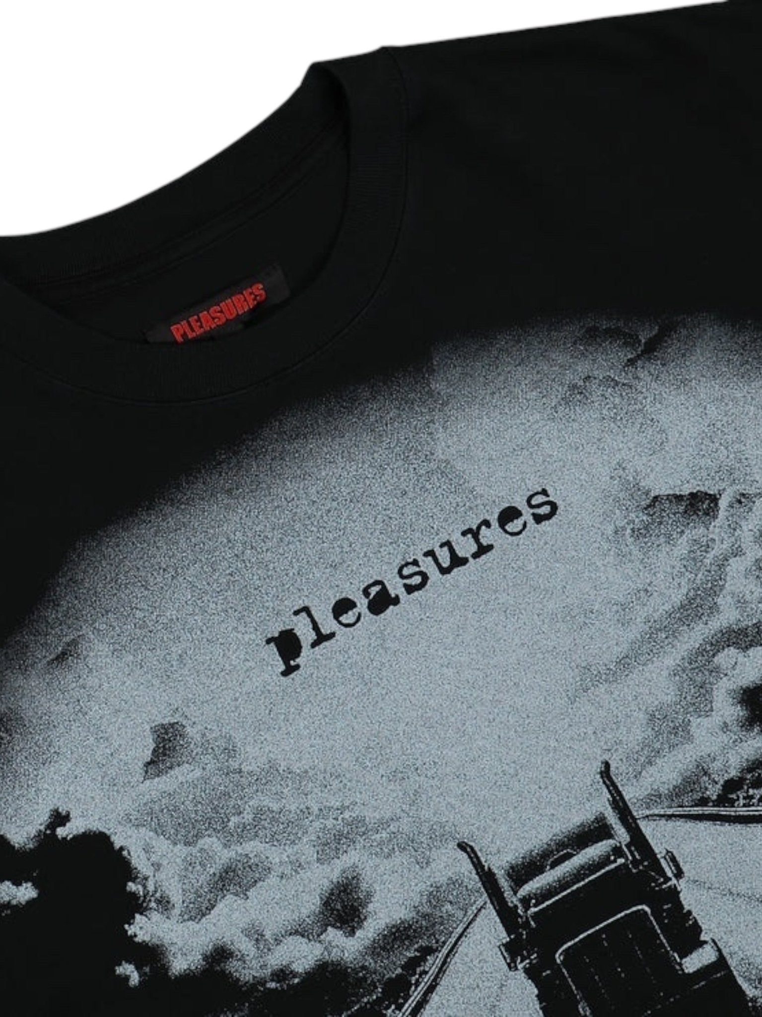 Presenting the Pleasures Truck Heavyweight Shirt Black from PLEASURES: a 100% cotton black t-shirt featuring "pleasures" in lowercase over an abstract backdrop with a partial truck image, merging comfort and unique style.