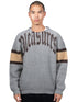Someone sports the "Pleasures Twitch Chunky Knit Sweat Grey," featuring wool blend and "PLEASURES" embroidery on the front, with chic brown and beige sleeve bands.