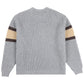 Back view of the Pleasures Twitch Chunky Knit Sweat Grey by PLEASURES, featuring brown and beige-striped sleeves, ribbed cuffs, and hem.