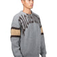 A person wears the Pleasures Twitch Chunky Knit Sweat Grey by PLEASURES, featuring a wool blend with brown and beige stripes, against a white backdrop.