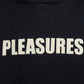 Close-up of the Pleasures Wave Quilted Hoodie Black by PLEASURES, showcasing a unique applique patch with "PLEASURES" embroidered in bold white letters.