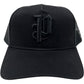 The Purple A2054-TTGT224 Cotton Twill Trucker Hat by PURPLE BRAND features a black mesh back and a raised Old English "P" embroidered on the front.
