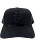 The Purple A2054-TTGT224 Cotton Twill Trucker Hat by PURPLE BRAND features a black mesh back and a raised Old English "P" embroidered on the front.