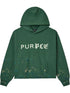 The Purple Brand M4104-HFGH425 Heavyweight Fleece Hoodie in green features an oversized fit, "PURPLE" crackle print on the chest, paint splatter details at hem and sleeves, a front pouch pocket, and is made from heavyweight cotton.