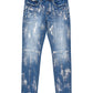 The Purple Brand P001-SAFC Angel Silver Foil Cross Indigo jeans by PURPLE BRAND feature a paint-splattered design, front pockets, and belt loops. Crafted from premium stretch denim, these low-rise skinny jeans showcase unique washes and dye methods for an eye-catching finish.