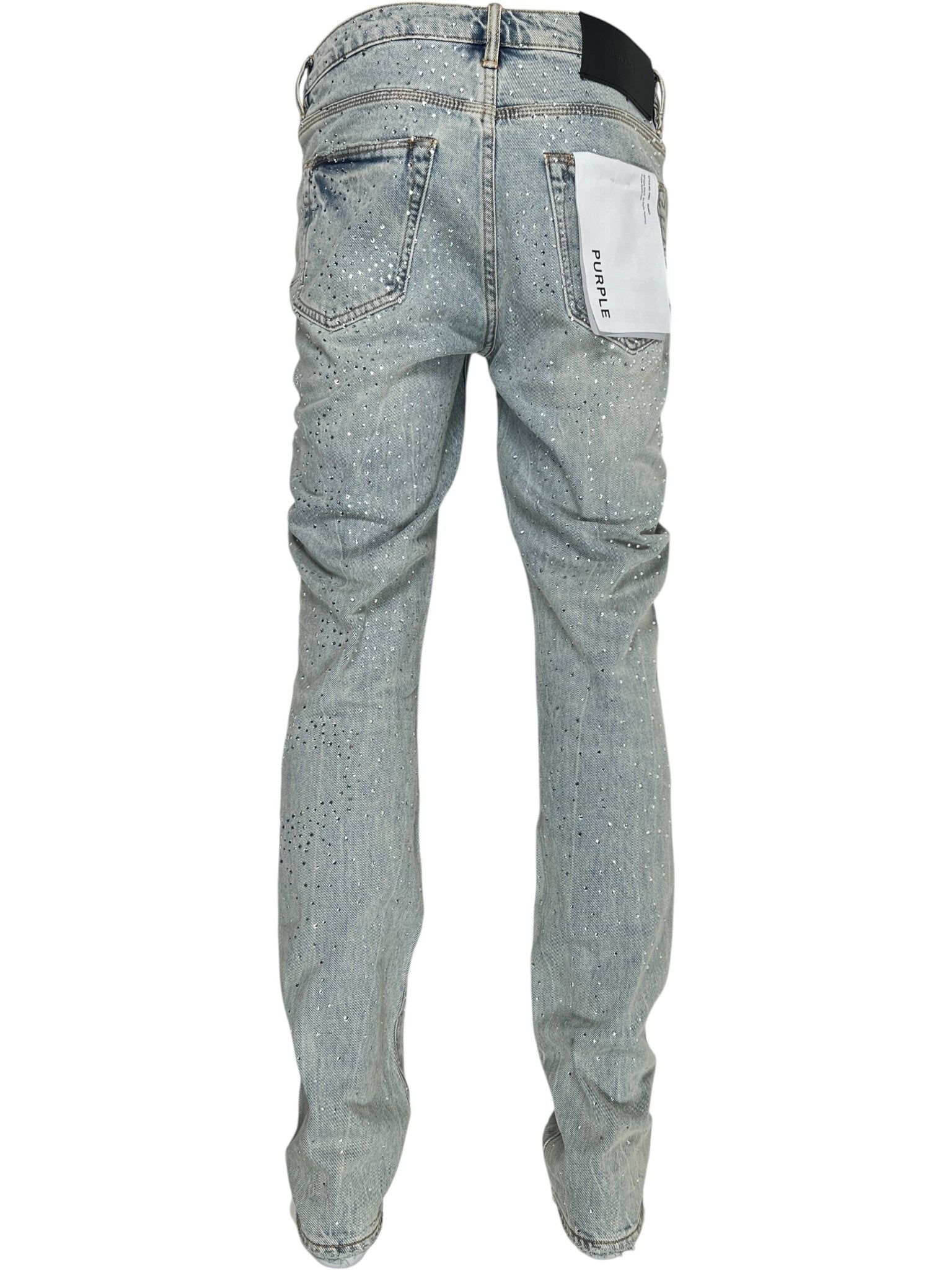 Back view of PURPLE BRAND P001-SALT425 Skinny Atlin Blitz Indigo jeans in premium stretch denim, featuring a white label on the right pocket, subtle distressing, and speckled detailing.