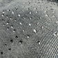 Close-up of light blue premium stretch denim adorned with scattered small, round rhinestones—perfect for elevating your PURPLE BRAND P001-SALT425 Skinny Atlin Blitz Indigo jeans collection.