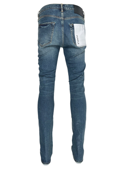 A pair of PURPLE BRAND P001-SDTE SKINNY COATED DK TEMPEST DK INDIGO jeans is displayed from the back, featuring two rear pockets and a white tag with P001 text attached to the right pocket.