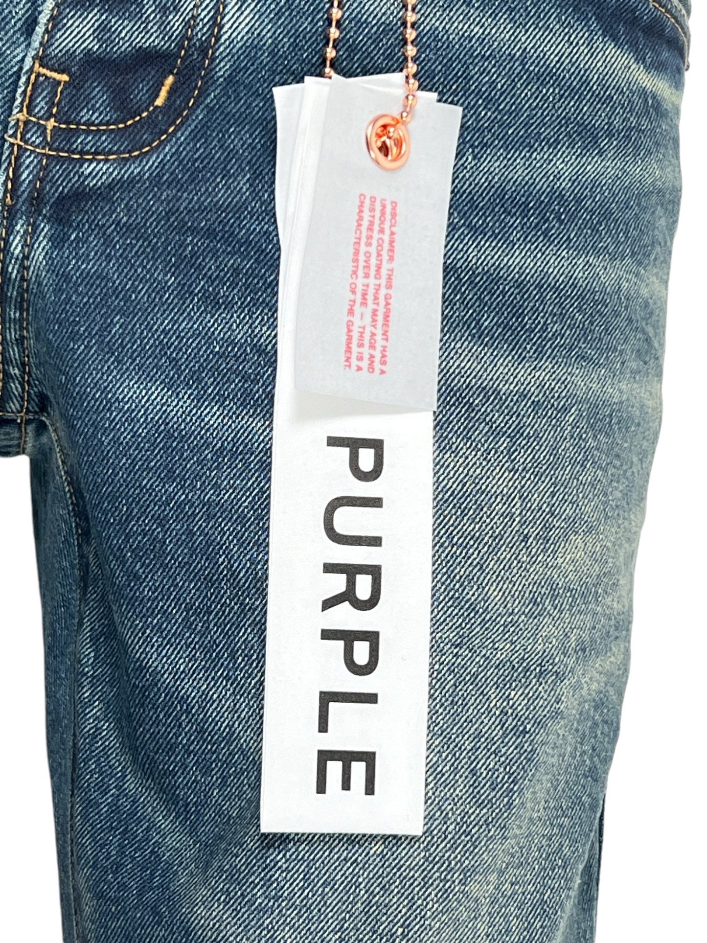 Close-up of PURPLE BRAND P001-SDTE Skinny Coated DK Tempest DK Indigo jeans with a tag labeled "P001" attached to a belt loop by a metal chain.