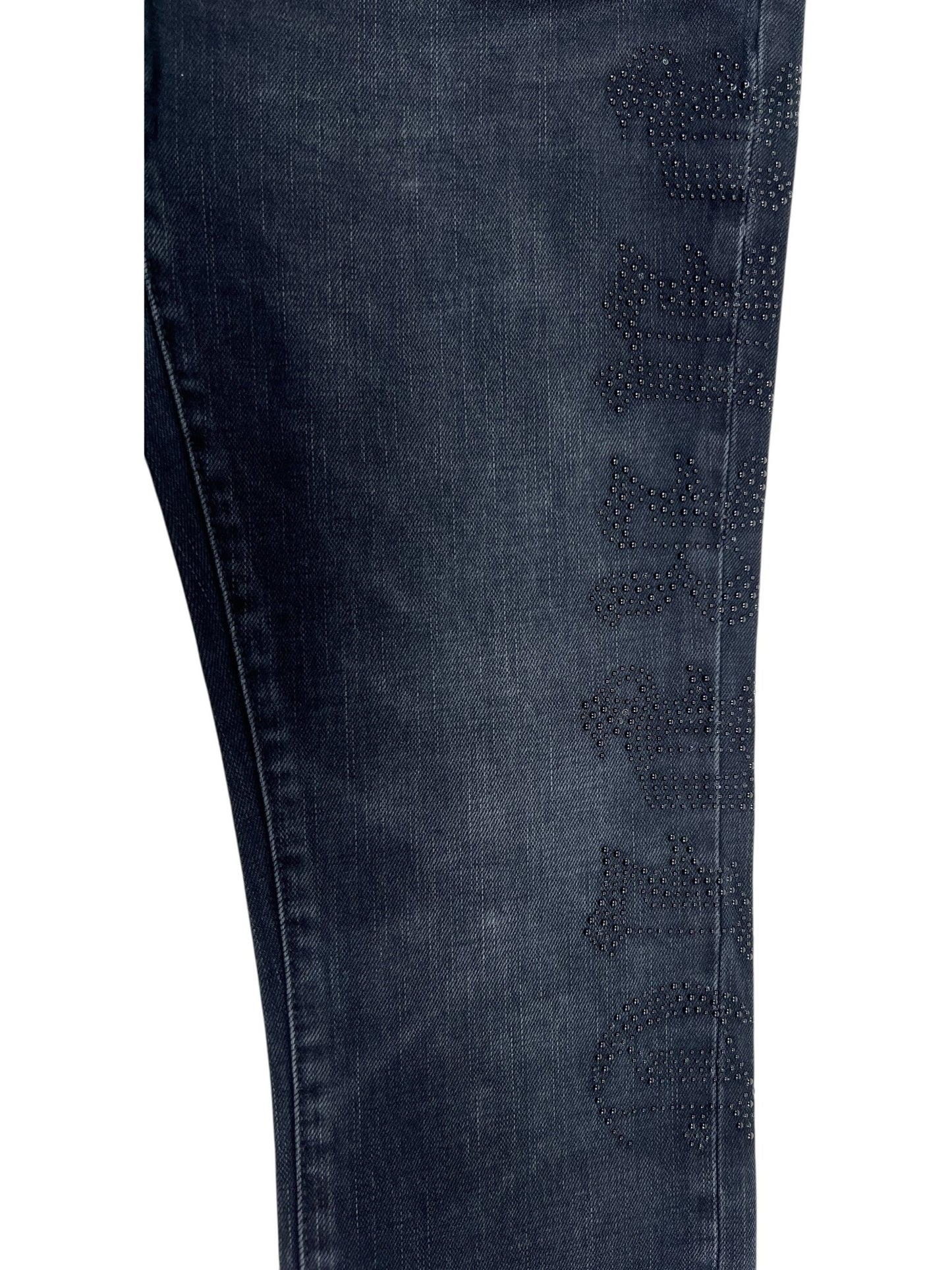 Close-up of a Probus Purple Brand P001-SHFL425 Skinny Hotfix Logo Black dark blue denim pant leg, detailed with decorative studs forming a subtle logo along the side.