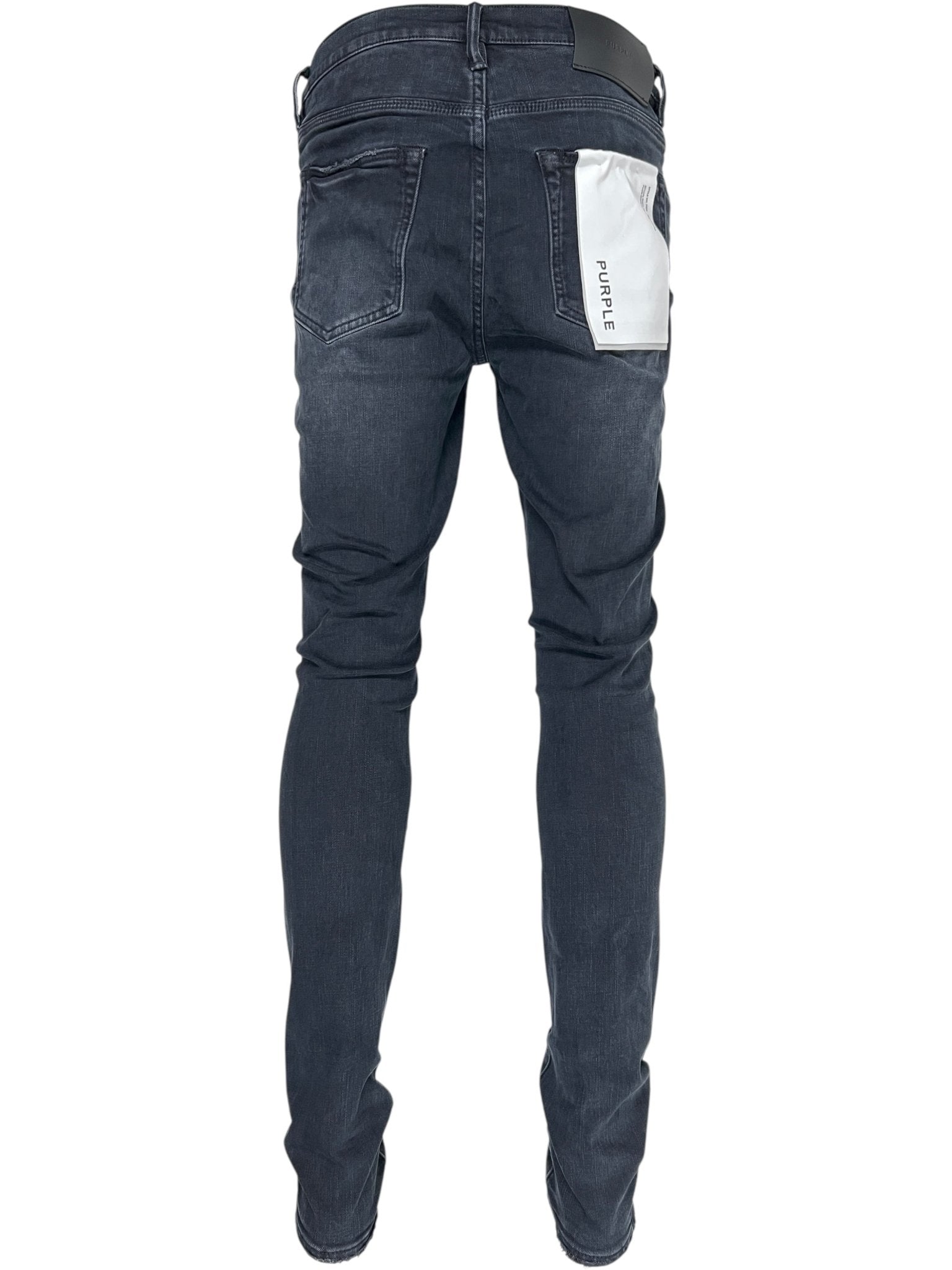 A person wearing Probus Purple Brand P001-SHFL425 Skinny Hotfix Logo Black jeans, featuring a white "PURPLE" patch on the back right pocket, viewed from behind.