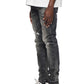 Individual dressed in the Purple Brand P001-SWKO Skinny Week Old Wash Black jeans, a white shirt, and black high-top sneakers against a white background.
