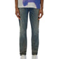 A person wears a blue and white shirt from the Spring/Summer 2025 White Label collection, paired with PURPLE BRAND's Skinny Cracked Bronze Denim (P001-SYCB) and white sneakers, standing with hands at sides.