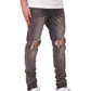 A person wearing a white t-shirt, white sneakers, and PURPLE BRAND Purple Brand P002-VWBO Vintage Worn Blowout Black distressed jeans stands against a plain background.