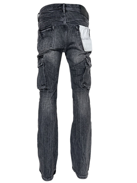 Back view of the PURPLE BRAND P004-CFTW CARGO FLARE TINTED WORN BLACK jeans, featuring multiple pockets and a distinctive white rectangular patch pocket on the left side. Designed in PURPLE BRAND's signature style, these gray denim jeans add a trendy twist with their cargo flare cut.