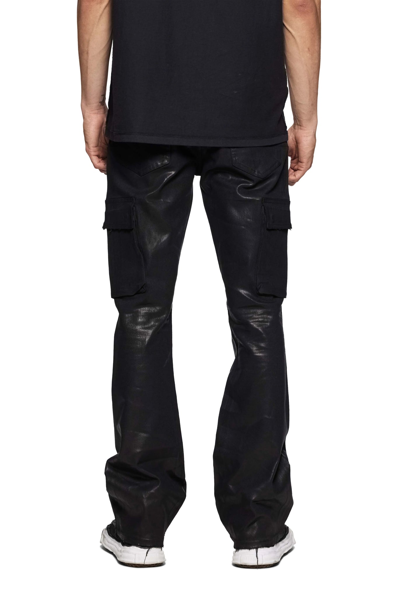 A person is wearing PURPLE BRAND's P004-CFVR Coated Cargo Flare Black pants with a black shirt, standing against a white background.
