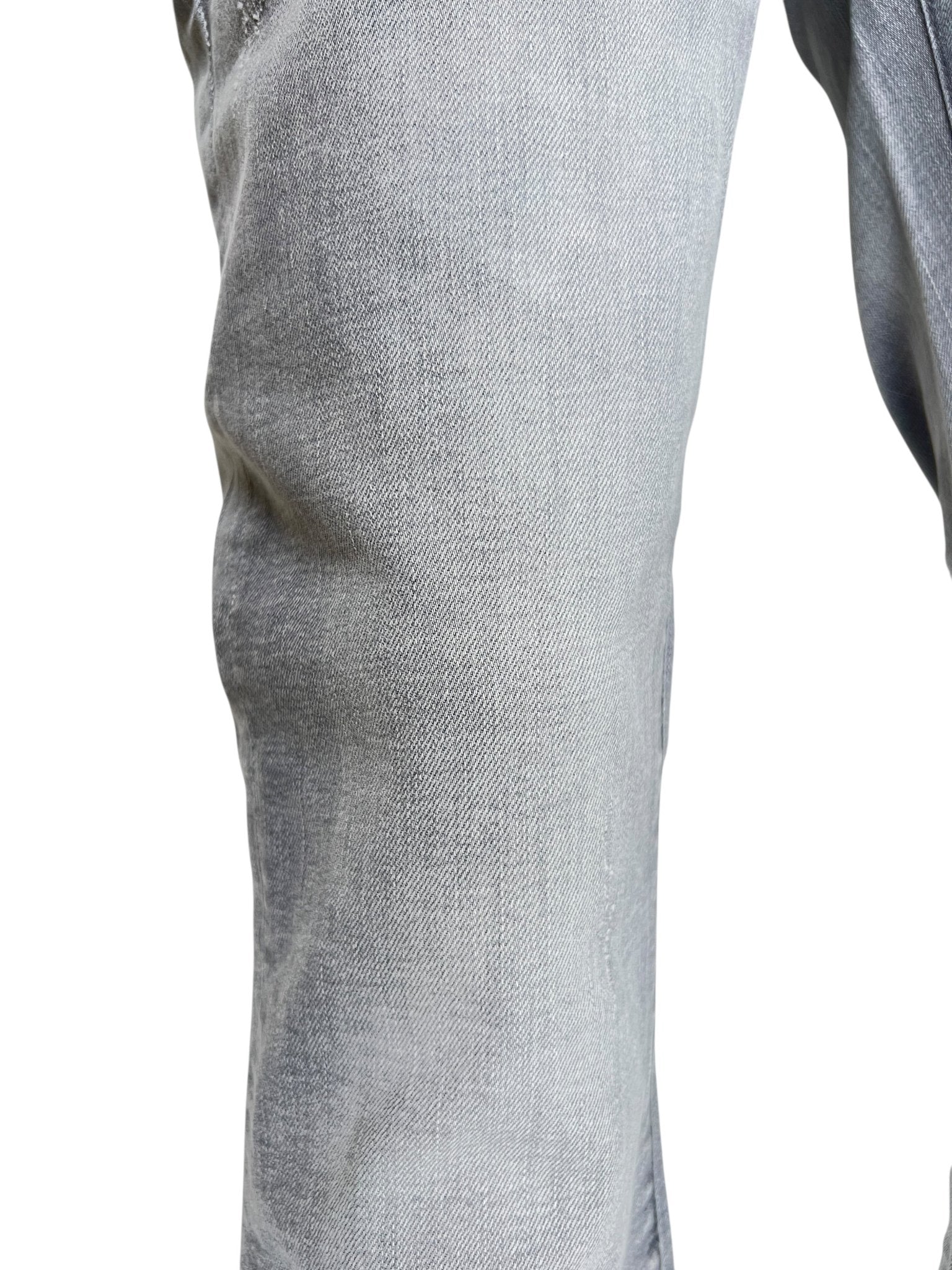 Close-up of a person wearing PURPLE BRAND P004-FTMY325 Flare Stormy Ski Grey men's jeans, showcasing the upper leg and knee in premium stretch denim.
