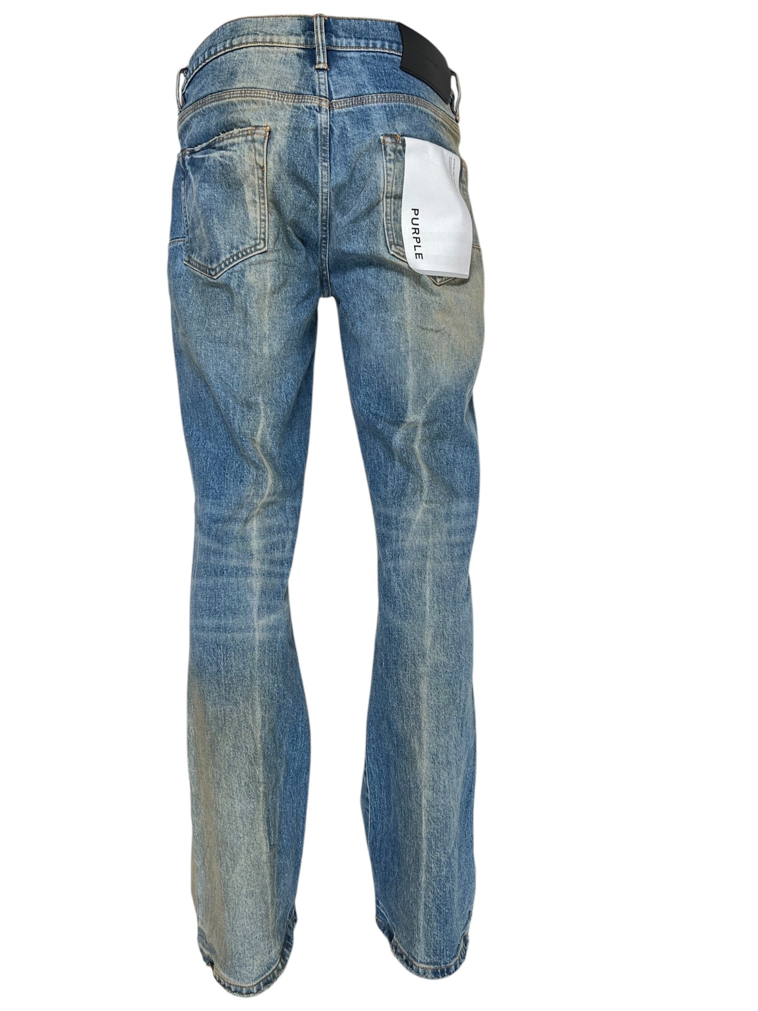 The PURPLE BRAND P004-GBMF Gaia Blowout Flare Indigo Denim features a rear view of stylish faded blue jeans with a "Purple" label on the back pocket, embodying the indigo trend. A must-have for Spring/Summer 2025, these jeans showcase the sophisticated style of Purple Brand denim.