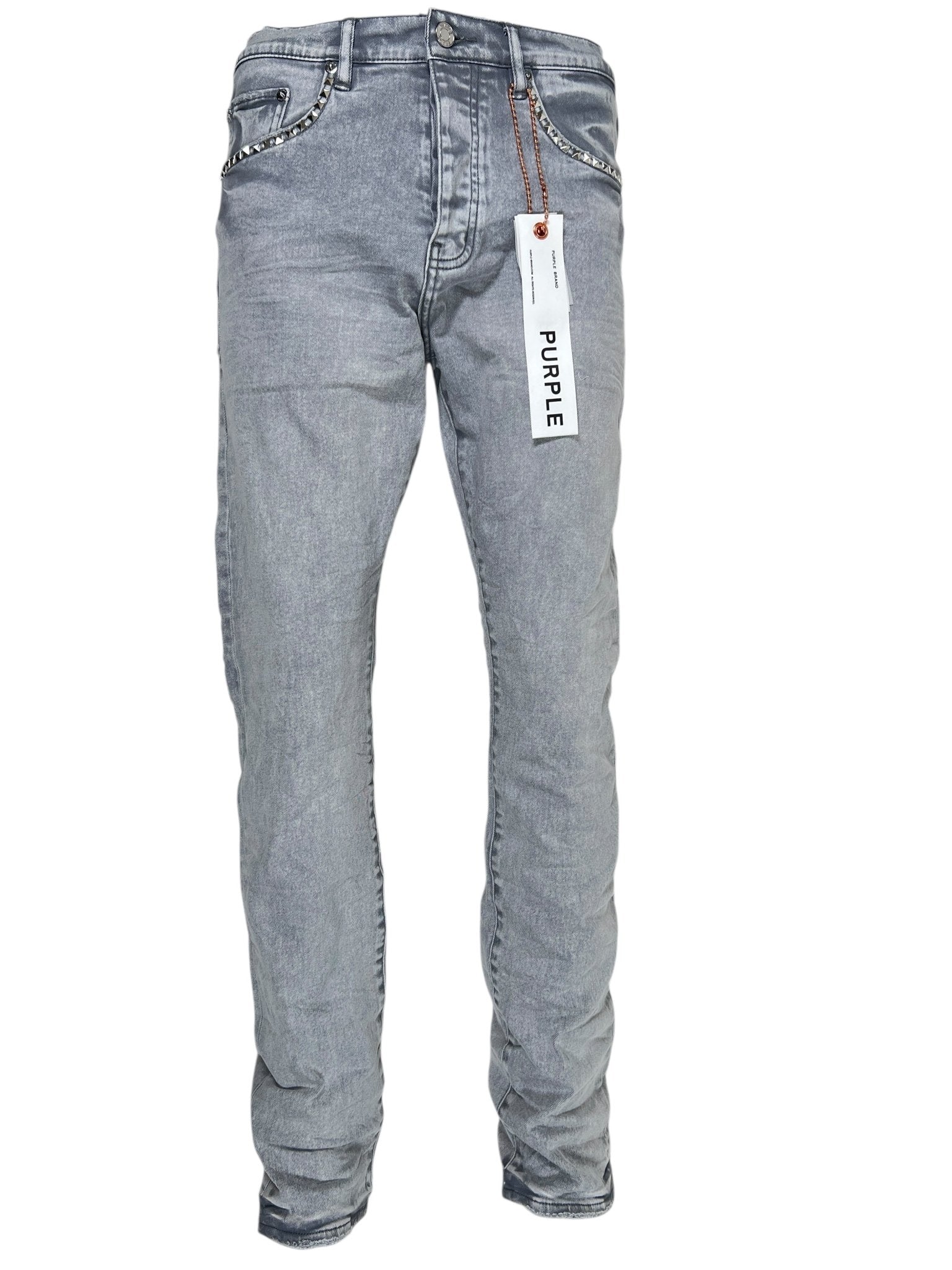 The Purple Brand P005-AYDG325 Alloy Studs Overdyed Grey jeans feature premium stretch denim in light gray, a button-fly closure, studded pocket accents, and a white "PURPLE" tag on a belt loop.