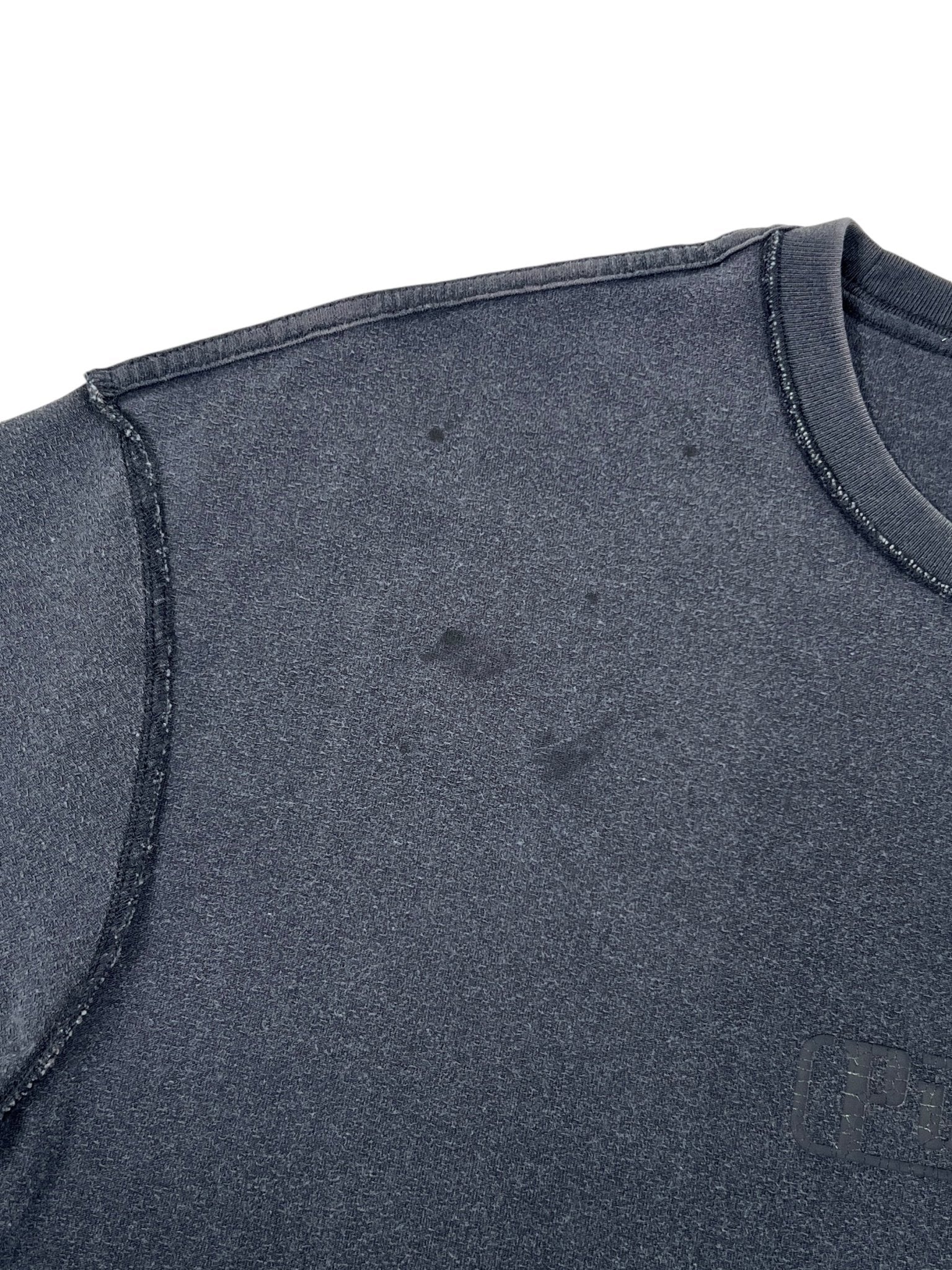 Purple Brand's P101-JBCP Textured Inside Out Tee BLK, made from 100% cotton, showcases a dark gray tie-dyed design with black stains near the shoulder.