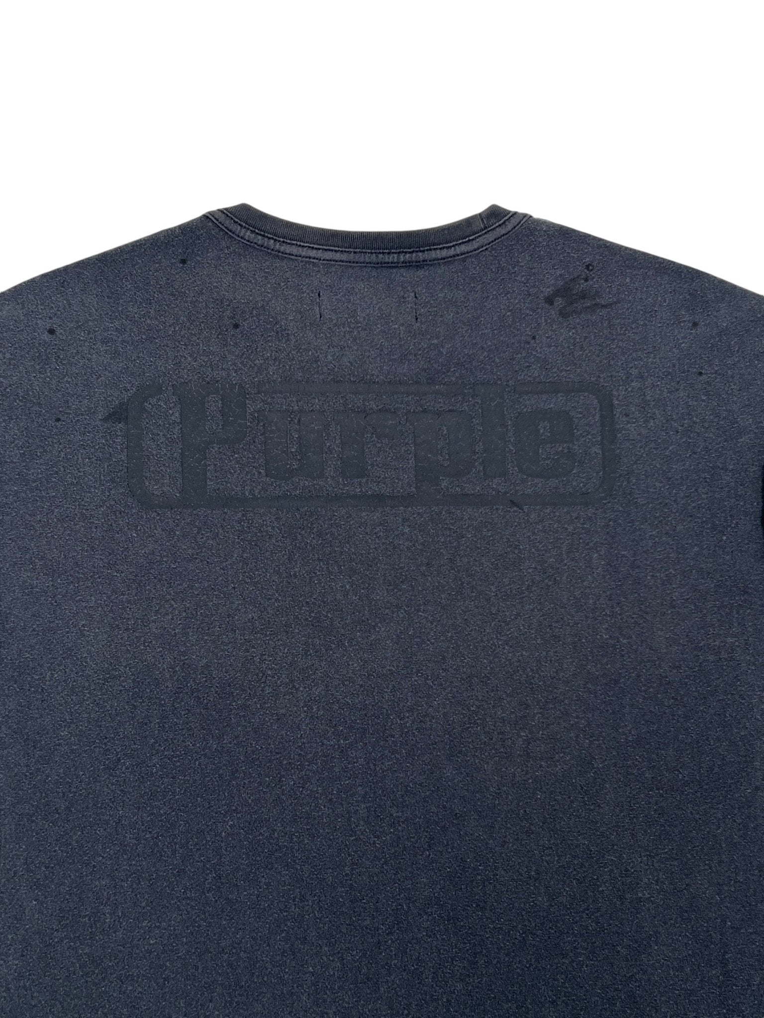 Back view of the Purple Brand P101-JBCP Textured Inside Out Tee in dark gray. Made from 100% cotton, it features a faded "Purple" logo, showcasing the subtle charm synonymous with PURPLE BRAND.