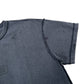 The Purple Brand P101-JBCP Textured Inside Out Tee BLK from PURPLE BRAND is a black short-sleeve T-shirt highlighting textured, slightly shiny 100% cotton fabric. Visible stitching marks the seams, complemented by subtle dark spots on its surface.