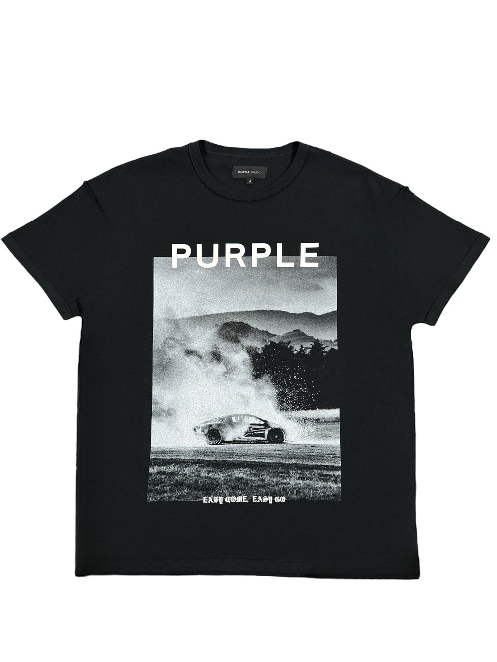 The Purple Brand P101-JBEG Textured Inside Out Tee in Black showcases a drifting car against a mountainous and tree-filled backdrop with "PURPLE" boldly displayed. Crafted from 100% cotton, this graphic tee also features the text "SAIKOHLE EARTH GO" underneath for a striking appearance.