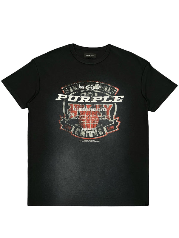 The PURPLE BRAND P101-JWBS Textured Inside Out Tee in black features a distressed print with purple text complemented by red and white accents. Made from 100% cotton, this stylish piece is a signature item from PURPLE BRAND.