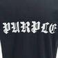 Introducing the Purple Brand P104-JGBB Textured Jersey Tee in Black by PURPLE BRAND, made from 100% cotton and featuring "PURPLE" in a white old English font across the chest. This premium black shirt combines comfort with style, making it perfect for fans of subtle gothic aesthetics.