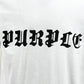 The Purple Brand P104-JGBW Textured Jersey Tee White, crafted from 100% cotton, showcases the "PURPLE" logo in an eye-catching black Gothic-style font.