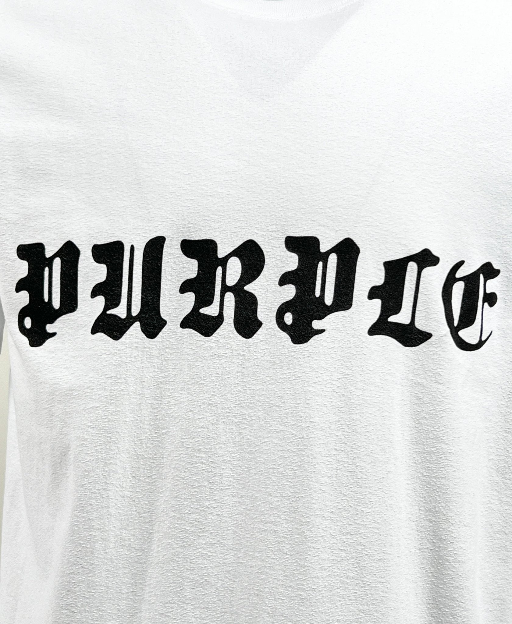 The Purple Brand P104-JGBW Textured Jersey Tee White, crafted from 100% cotton, showcases the "PURPLE" logo in an eye-catching black Gothic-style font.