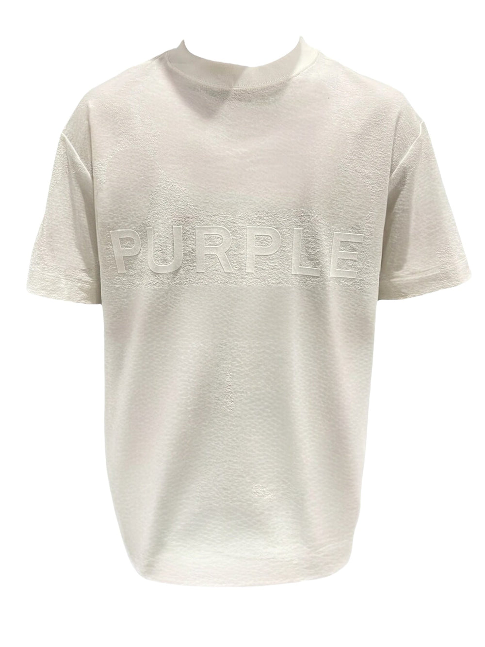 The Purple Brand P104-JWCM Textured Jersey SS Tee Off White by PURPLE BRAND is perfect for minimalists, showcasing the word "PURPLE" embossed on the front. Made from 100% cotton, it offers both comfort and style.