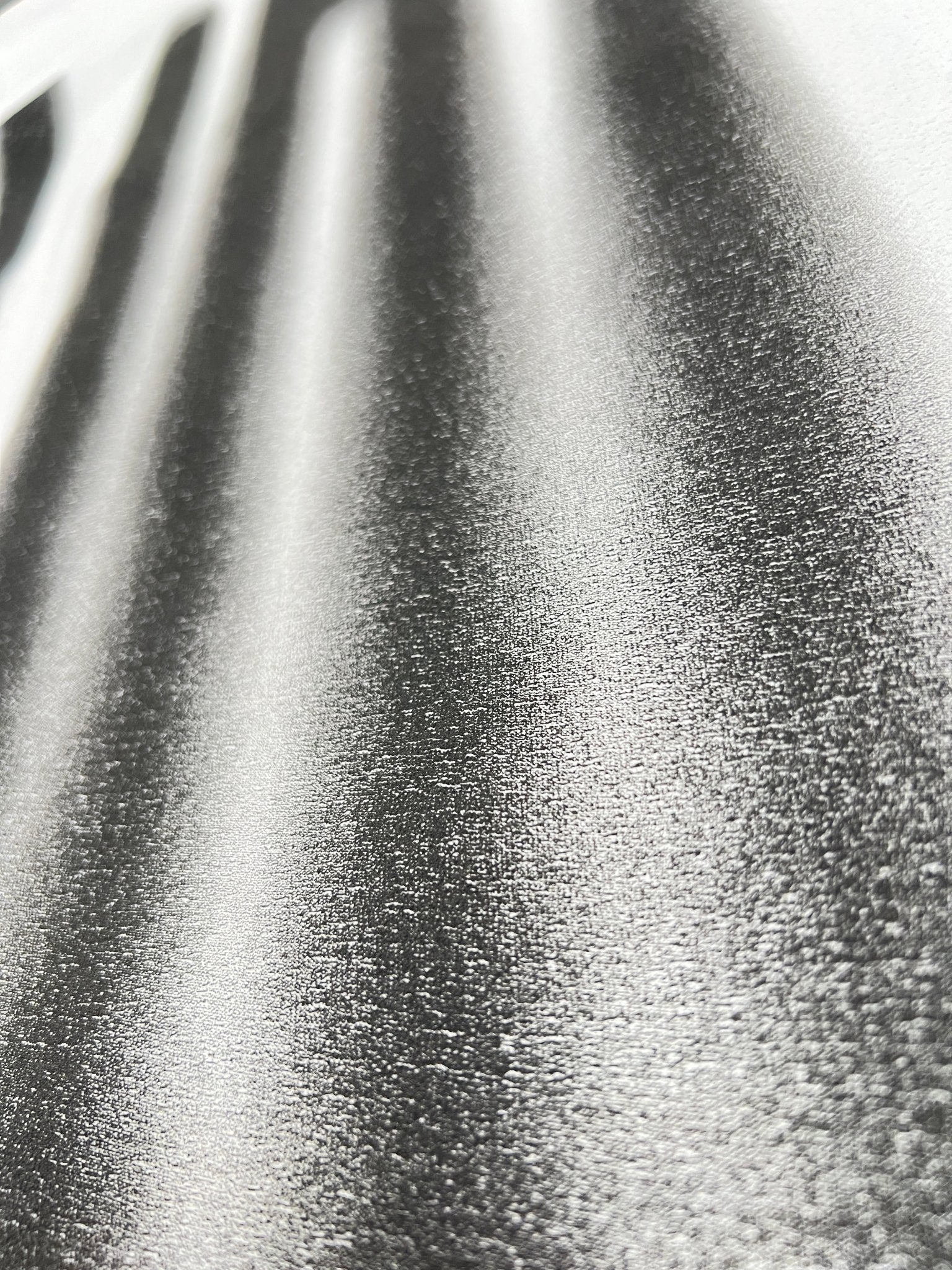 Close-up of the PURPLE BRAND P104-TBWB Textured Jersey SS Tee in white, showcasing its metallic-like, corrugated texture with bold, shadowed stripes reminiscent of graphic T-shirt designs.