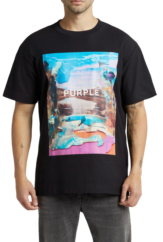 Man wearing a PURPLE BRAND P104-TJWB TEXTURED JERSEY SS TEE BLACK with a colorful abstract design and the word "purple" printed on it.